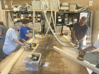 Volunteers sand boards